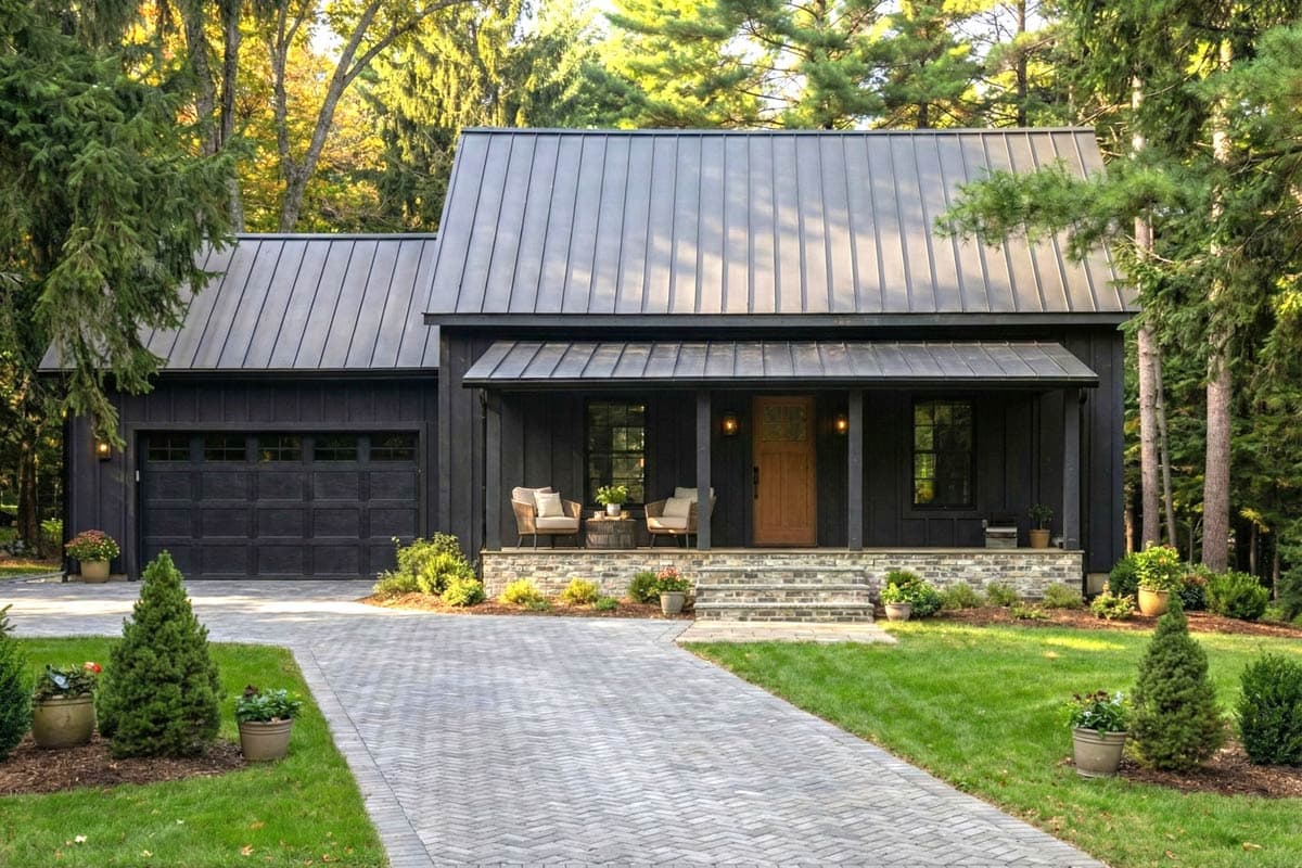 Modern Farmhouse house plan exterior with vertical siding, metal roof, covered porch with stone accents, and attached garage.