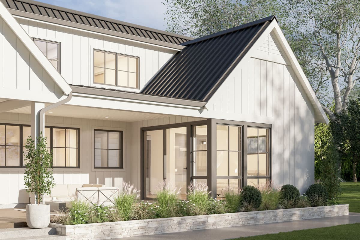 Modern farmhouse exterior with a gable roof, vertical siding, covered porch, and large grid windows.
