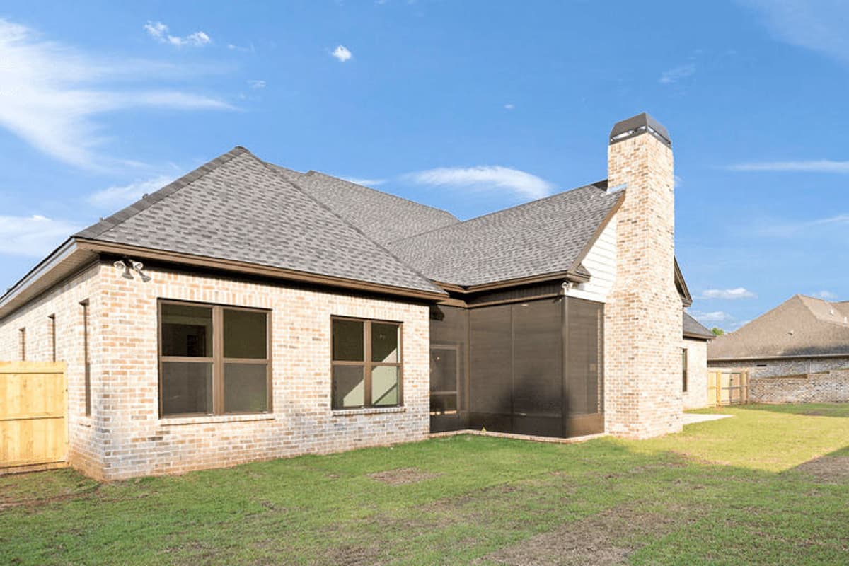 House plan exterior: One-story brick home with gable rooflines, a prominent brick chimney, and a screened porch.