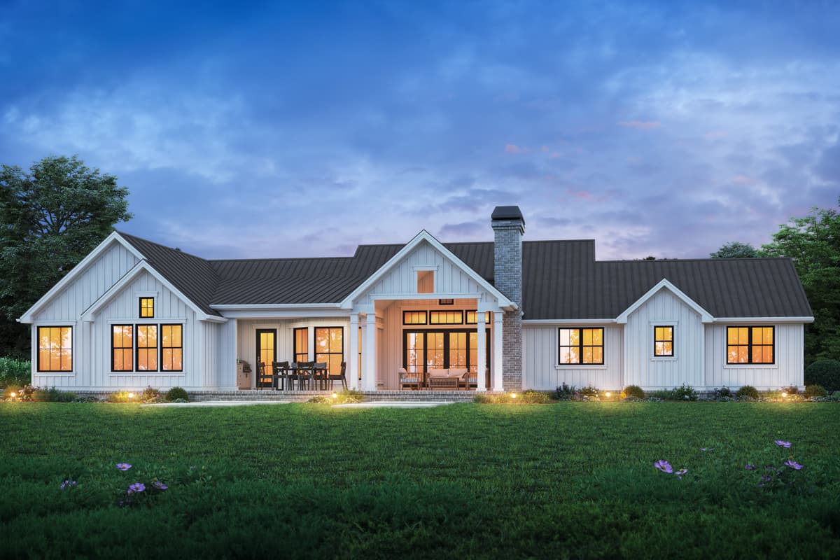 Modern Farmhouse house plan exterior: one story, white board and batten siding, gable dormers, covered porch with stone chimney.