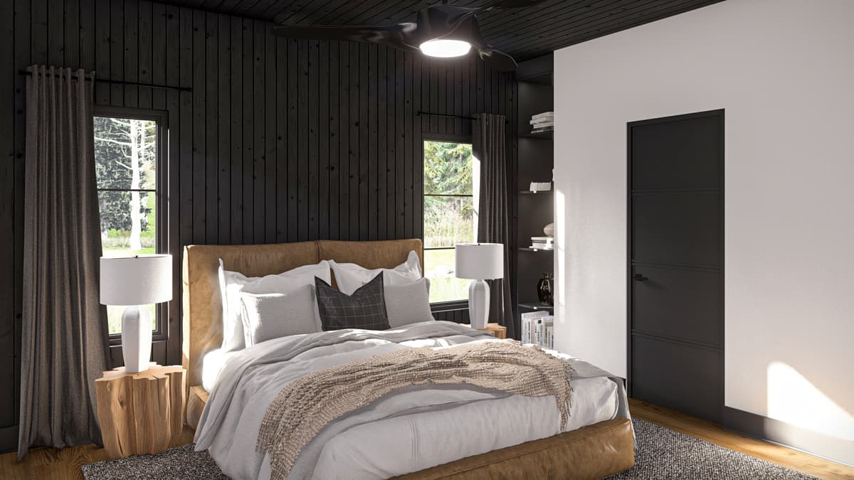 Bedroom interior with paneled wood walls, leather headboard, two windows, and a black door.