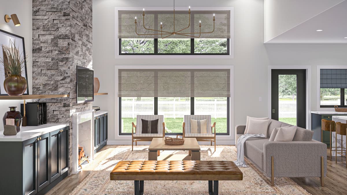 Living room with stone fireplace, large windows, sofa, and seating.