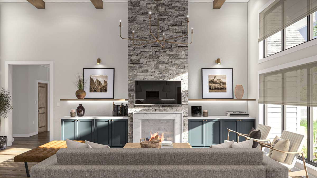 Living room with a stone fireplace, TV, vaulted ceiling with beams, and large windows.