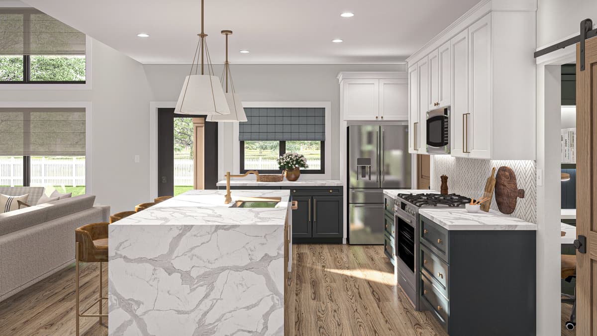 Kitchen with island, marble countertops, stainless steel appliances, white upper cabinets, and dark lower cabinets.