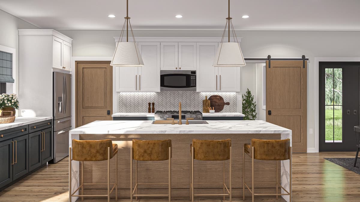 Kitchen with white cabinets, marble-topped island with seating, stainless steel appliances, and barn door.