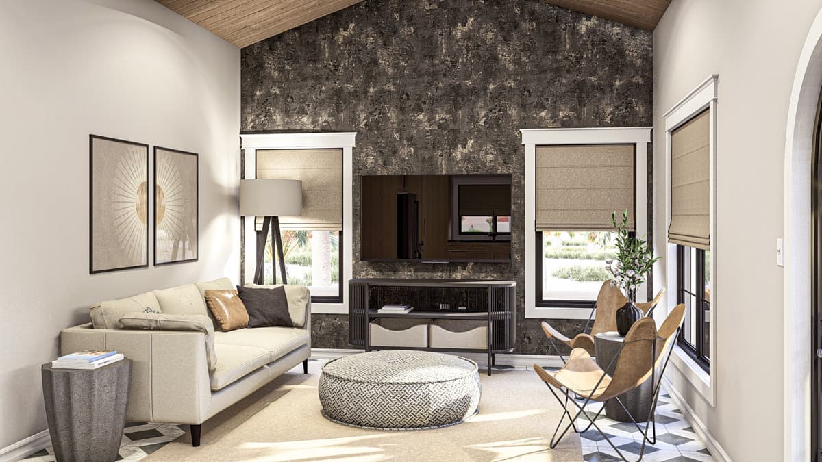 Living room with vaulted ceiling, textured accent wall, sofa, ottoman, and butterfly chairs.
