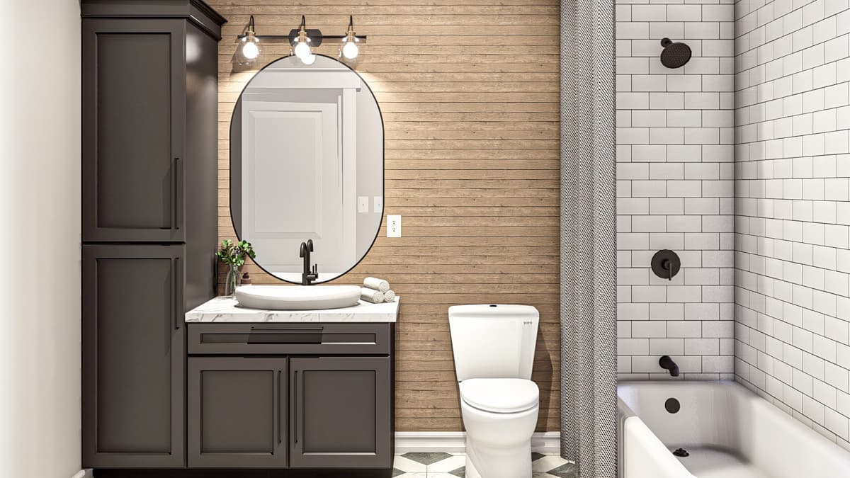 Bathroom with dark gray vanity, oval mirror, wood-paneled accent wall, subway tile shower surround, and bathtub.