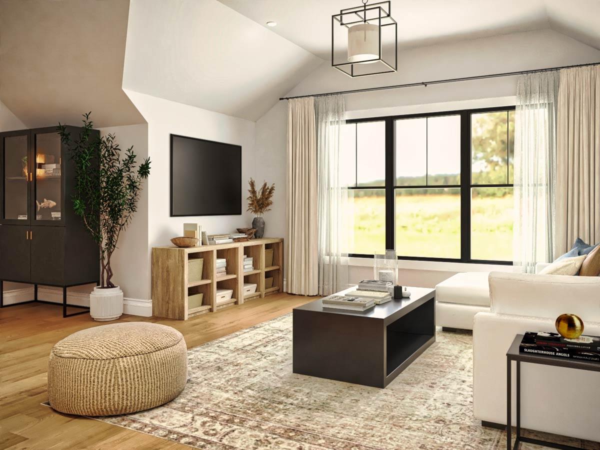 A cozy living room with a large window overlooking a field, a TV, and a coffee table. Features a neutral color palette.