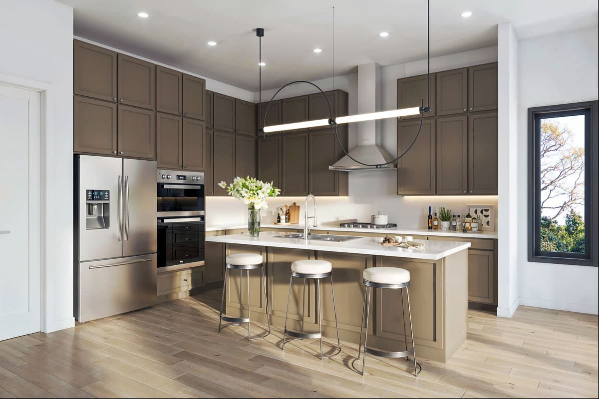 Kitchen with stainless steel appliances, island with sink, and taupe cabinetry.