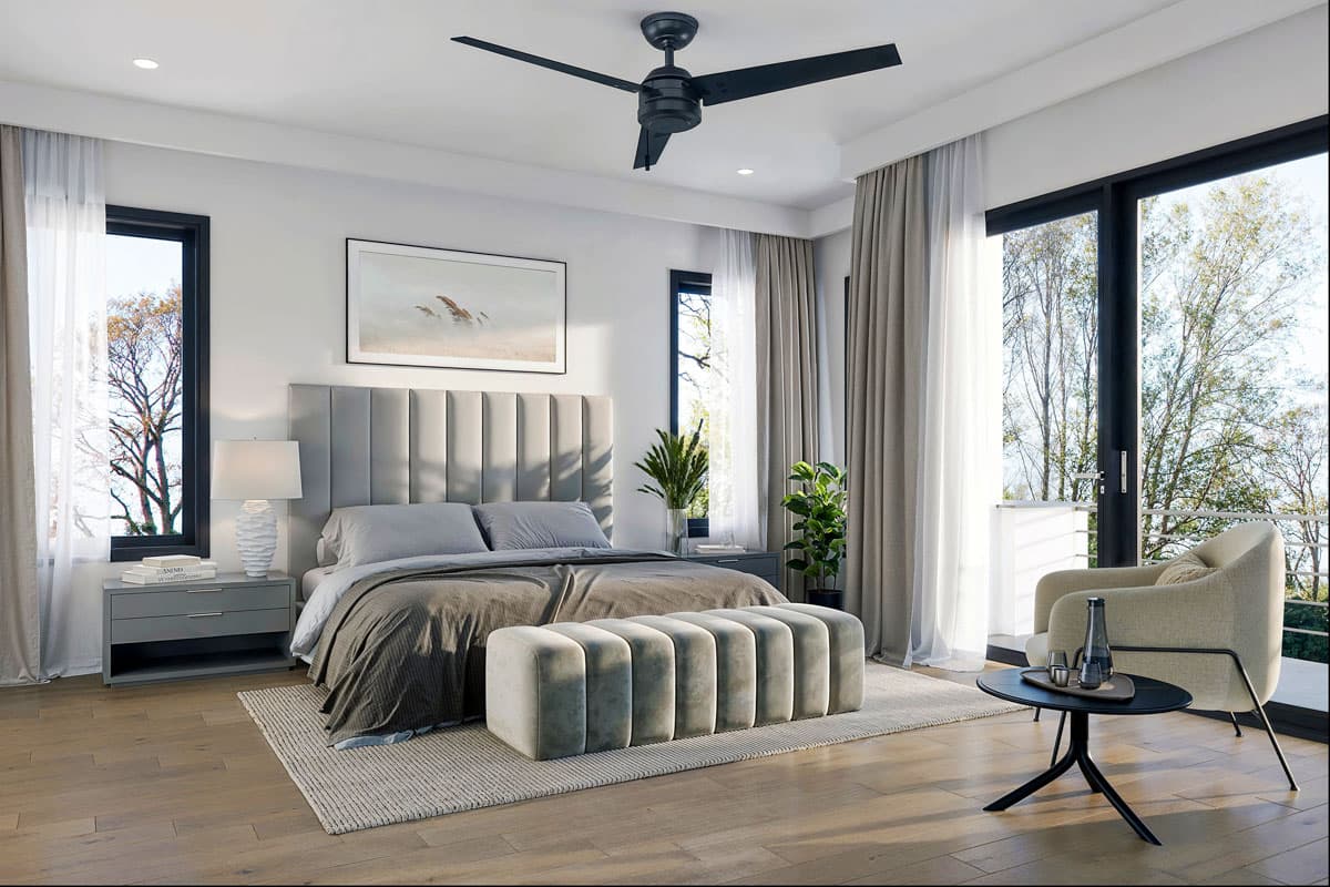 Primary bedroom with upholstered headboard, large windows, sliding glass doors, and modern furnishings.