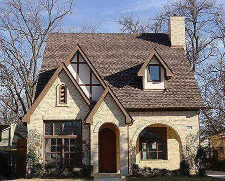 House plan exterior: Two-story Tudor style with prominent gables, arched entry, and decorative half-timbering.