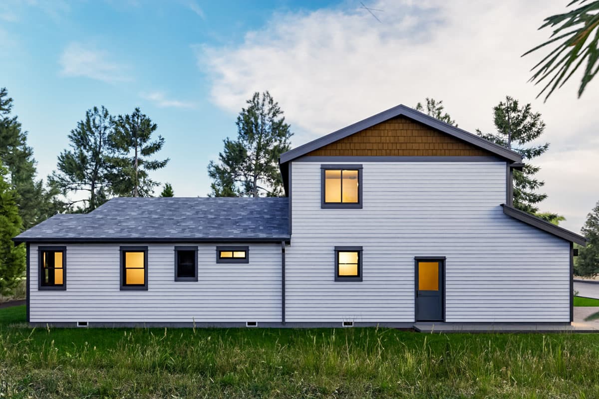 House plan exterior: Two-story home with gabled roof, horizontal siding, and varied window sizes. Features shingled gable detail.