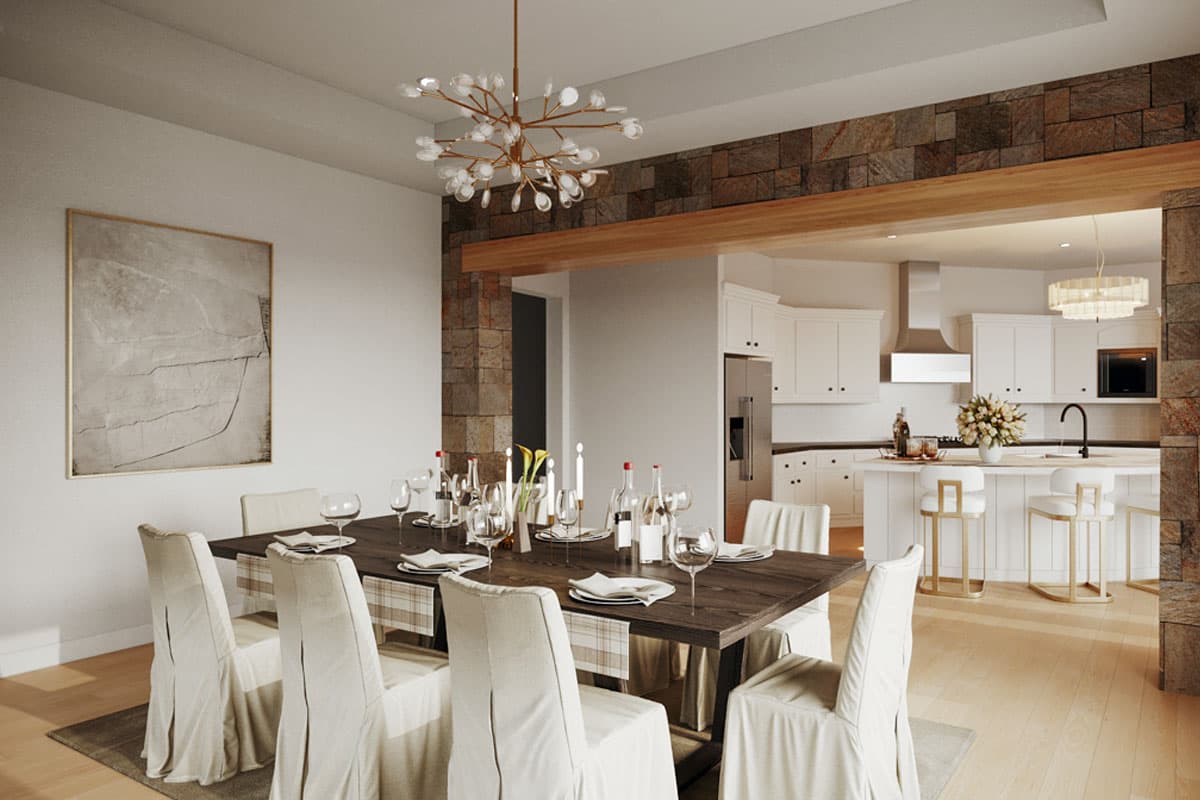 Dining area with stone accent wall and open kitchen featuring island with bar stools.