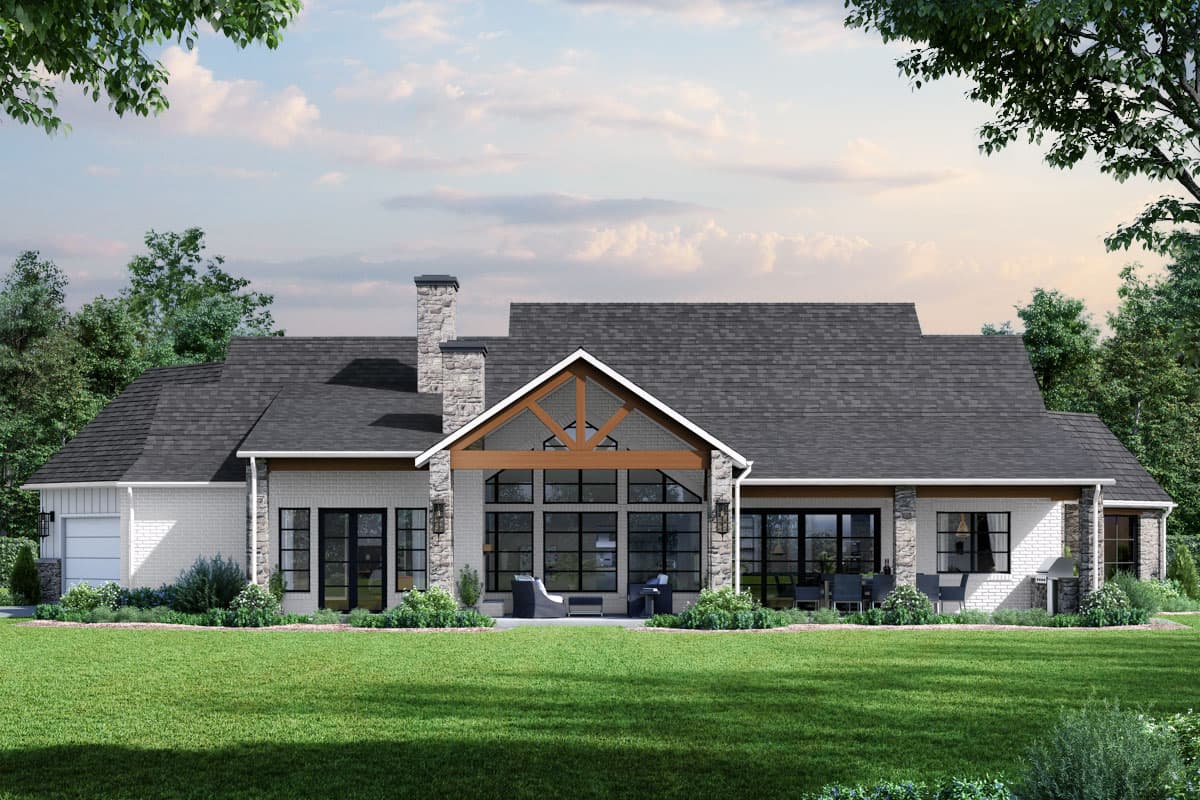 House plan exterior: Ranch-style, single-story, white brick with stone accents, large gable dormer, stone chimney, and attached garage.