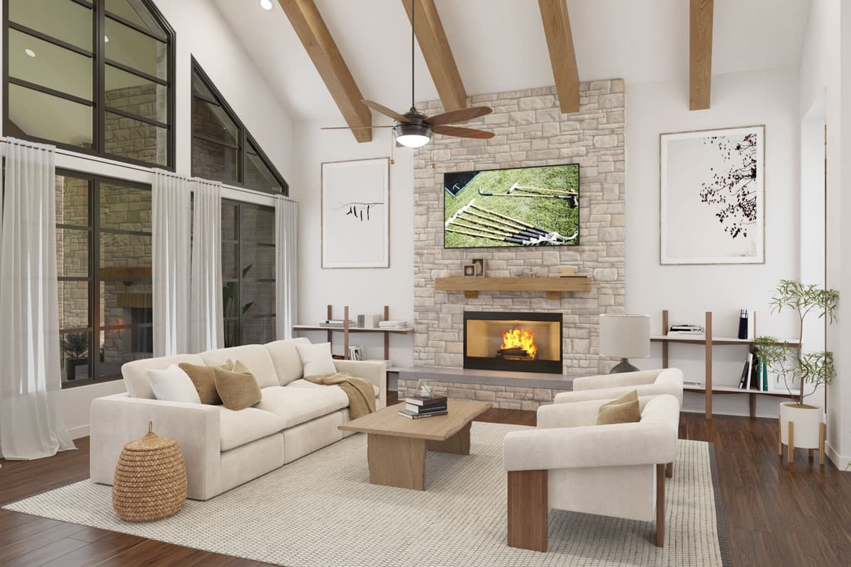 Great room with vaulted ceiling, exposed beams, stone fireplace, and large windows. Includes sectional sofa and chairs.