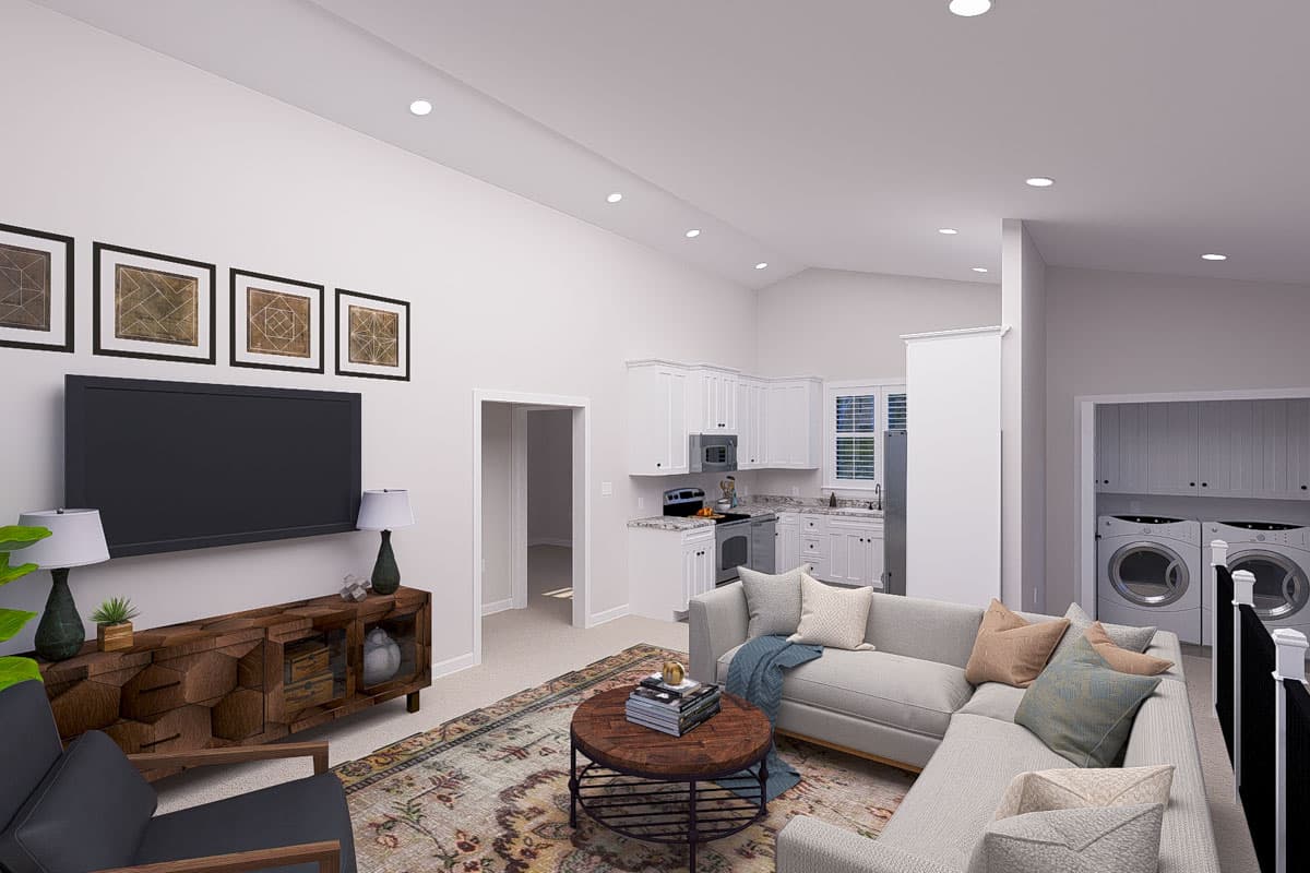 Interior rendering of a great room with vaulted ceiling, kitchen, and laundry area. Features include sectional sofa, island, and built-in cabinets.