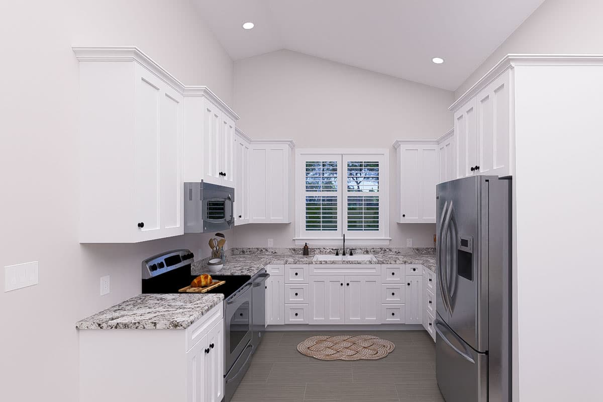 Kitchen with white cabinets, granite countertops, stainless steel appliances, and vaulted ceiling.