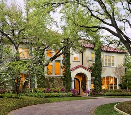 Mediterranean style house plan exterior with arched entryway, red tile roof, and multiple large windows.