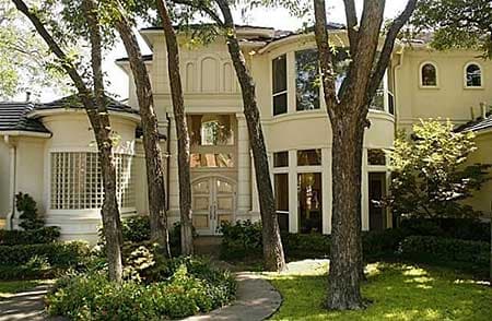 House plan exterior with double entry doors, arched windows, curved bay windows, and glass block window.