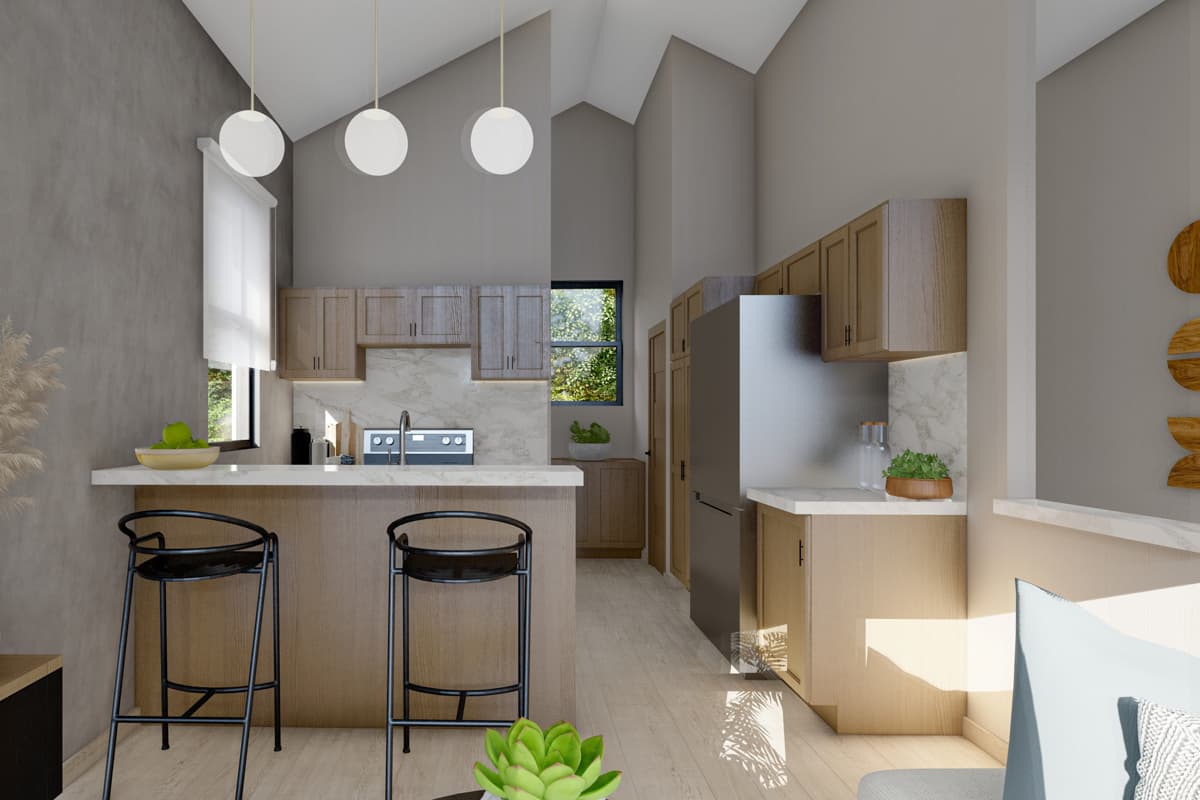 Kitchen and dining area with vaulted ceiling, island with bar stools, wood cabinets, marble backsplash, and stainless steel refrigerator.