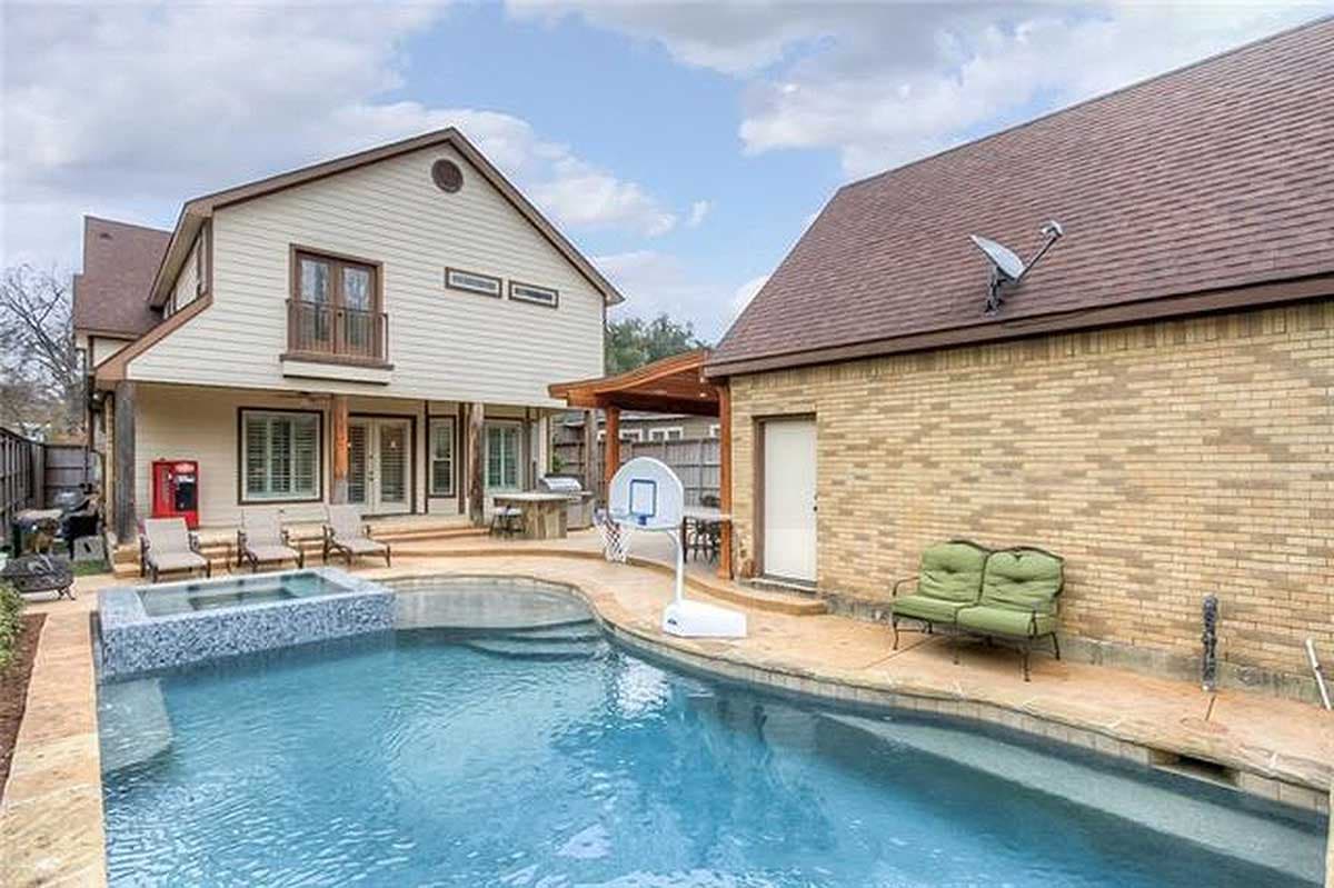Two-story house plan exterior with a covered patio, pool, spa, and detached brick garage.