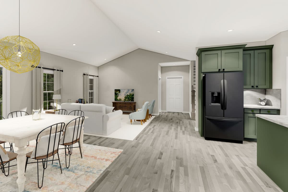 Open-concept living area with vaulted ceiling, dining area, living room, and kitchen with green cabinetry and black refrigerator.