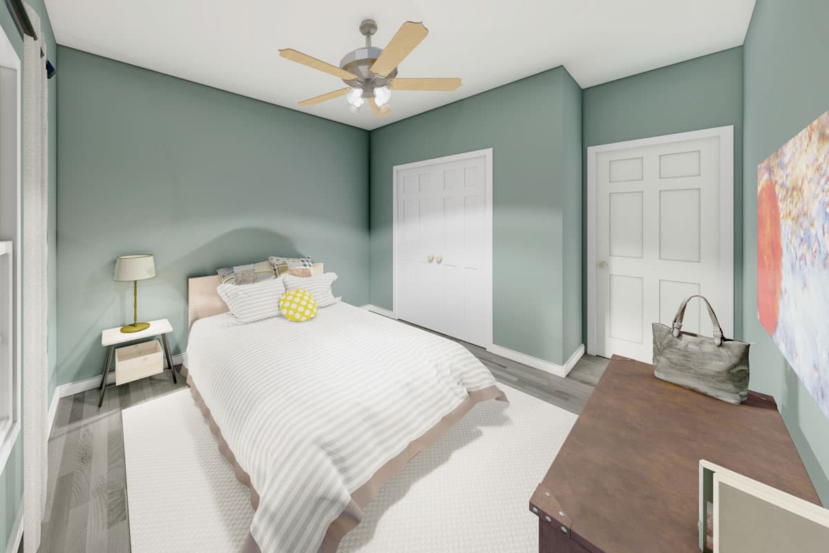 Bedroom with a bed, ceiling fan, closet doors, and a side table.