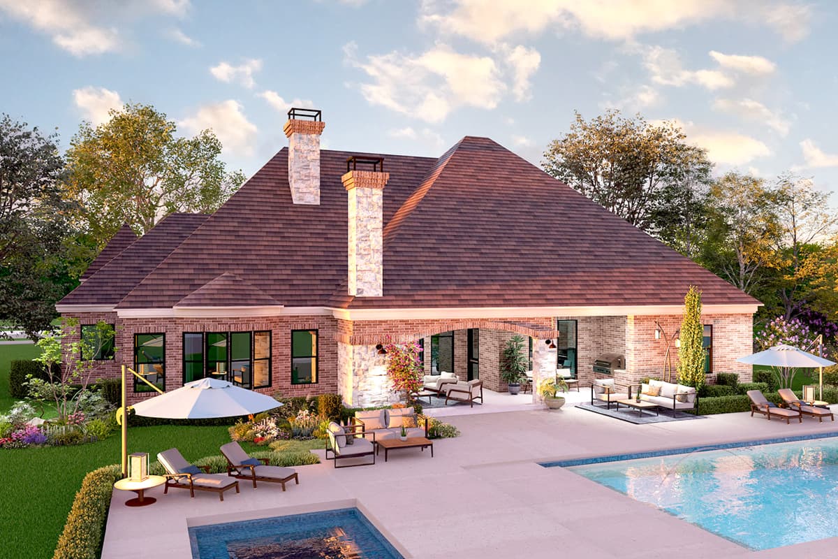 House plan exterior rendering shows a one-story brick home with a large hip roof, two stone chimneys, and an covered outdoor living area.