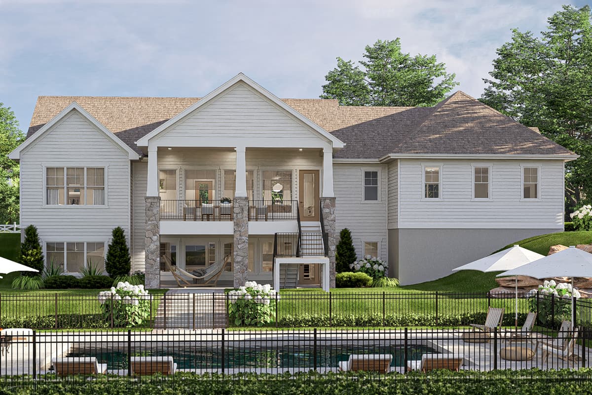 House plan exterior showing a two-story Modern Farmhouse with a covered upper deck supported by stone columns, gables, and a two-car garage.