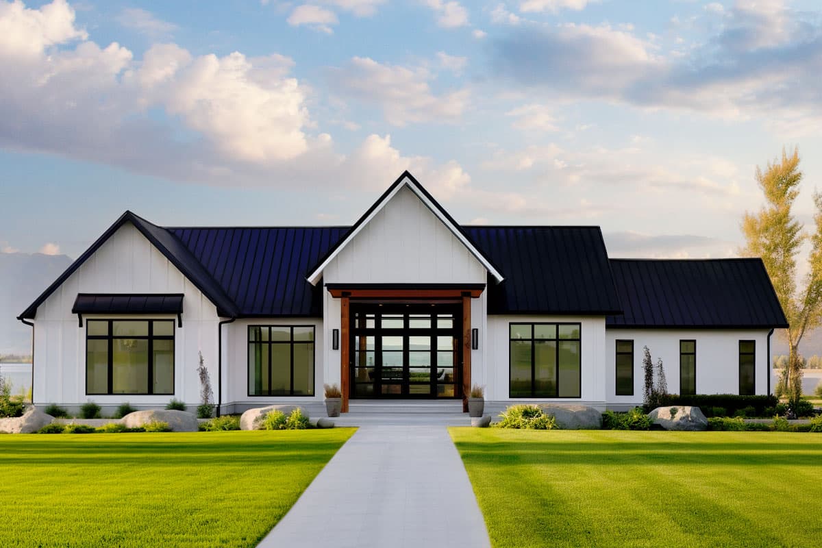 House plan exterior. Modern farmhouse style with one story, gable roof, dark metal roof, and large windows. Includes a covered entryway.