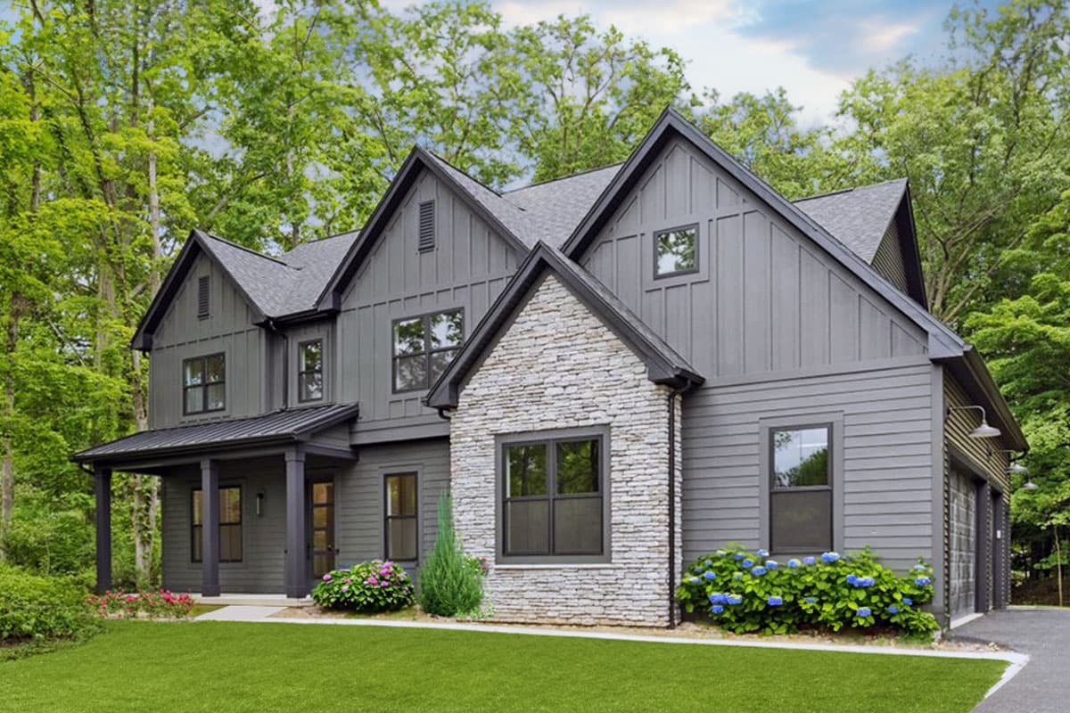 Modern Farmhouse house plan exterior with stone accent, board and batten siding, gables, and covered porch.
