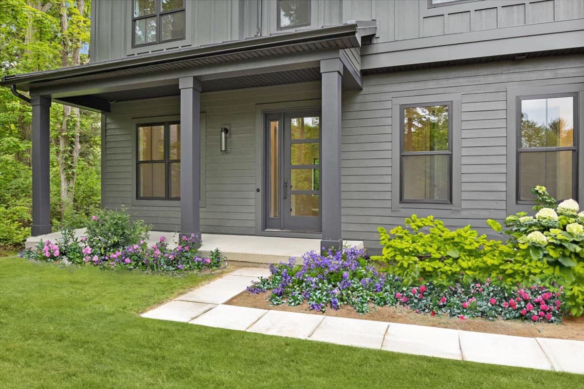 Modern house plan exterior with covered porch, clean lines, and natural siding.