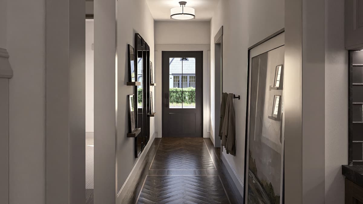 Hallway interior with dark wood herringbone floors, a dark front door with glass panes, and a tall mirrored art piece.