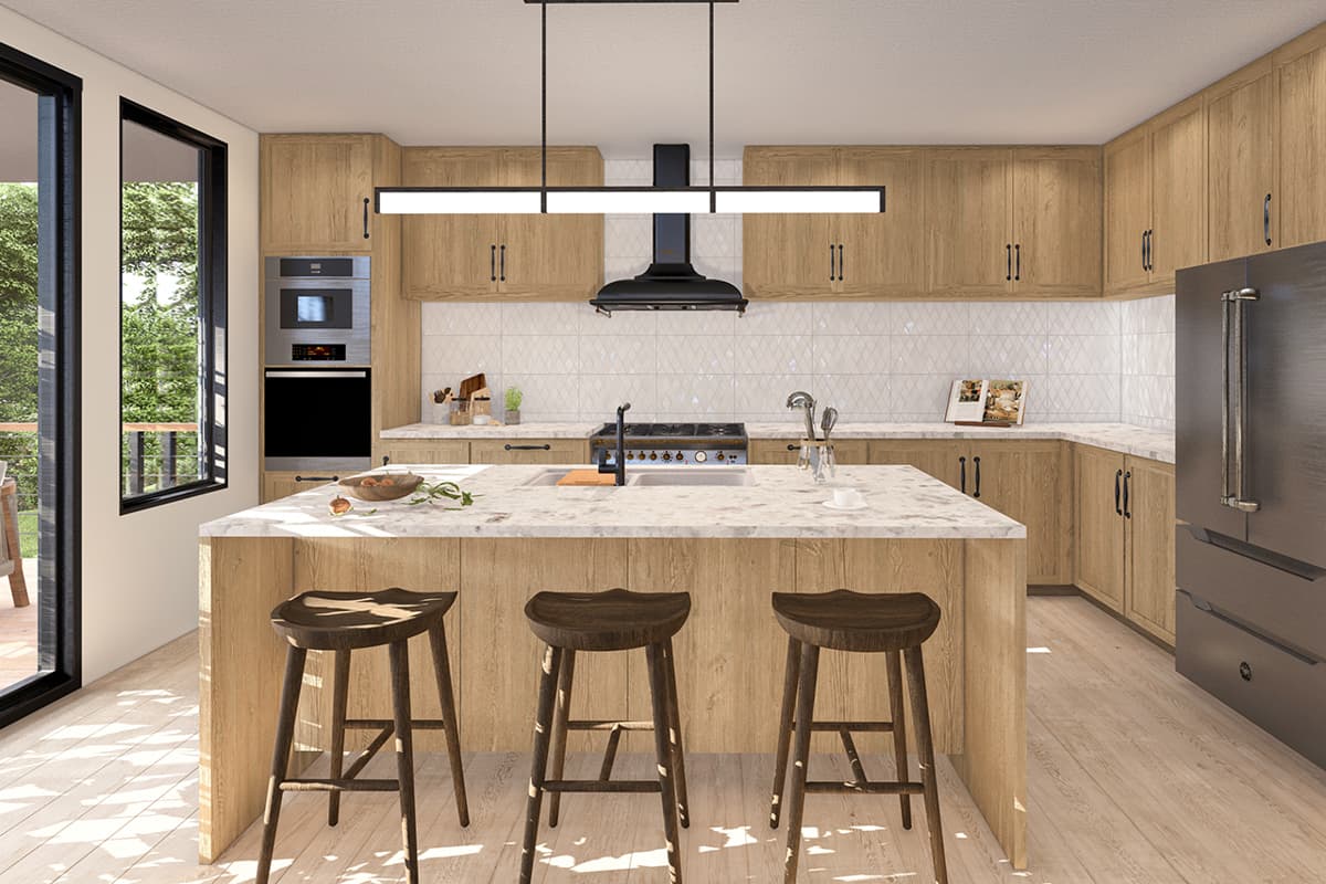 Kitchen with wood cabinetry, island with seating, stainless steel appliances, and large windows overlooking trees.