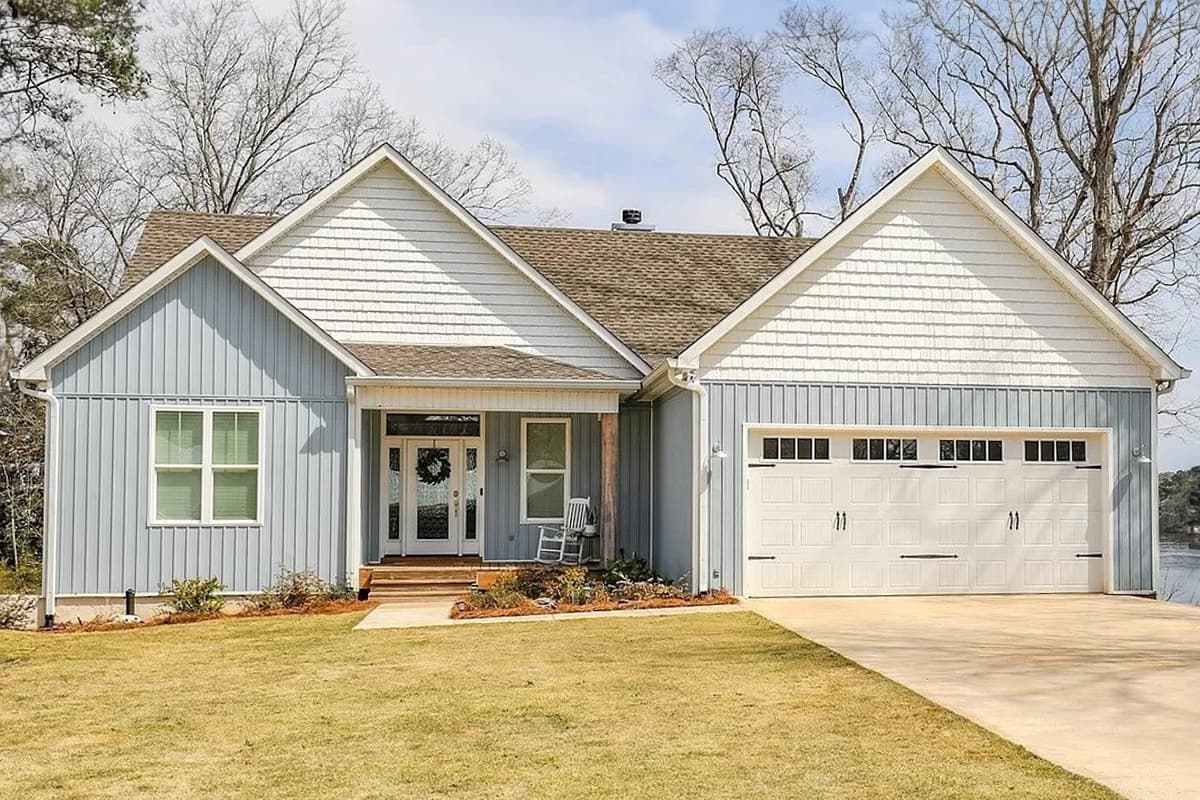 House plan exterior: Modern Farmhouse style, one story, featuring a covered porch with wood columns, mixed siding, and a two-car garage.
