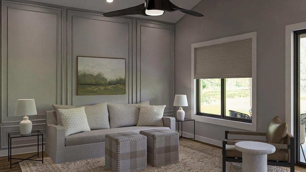 Living room with paneled walls, sofa, two ottomans, accent chair, and large window. Modern ceiling fan.
