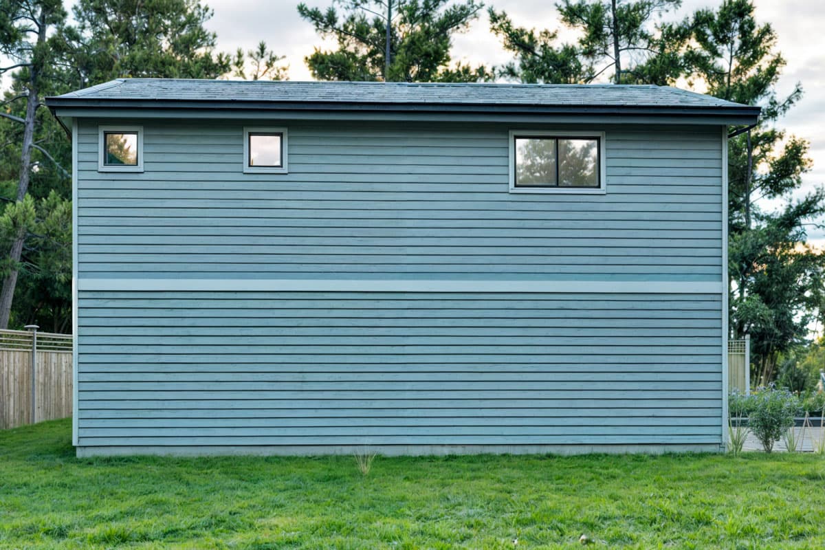 House plan exterior, two stories, horizontal siding, and three windows.