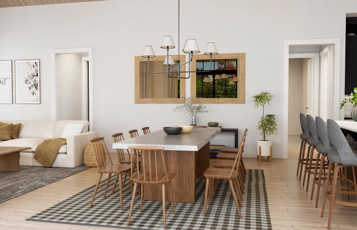 Open concept dining and living area with a concrete table, wooden chairs, sectional sofa, and bar seating.