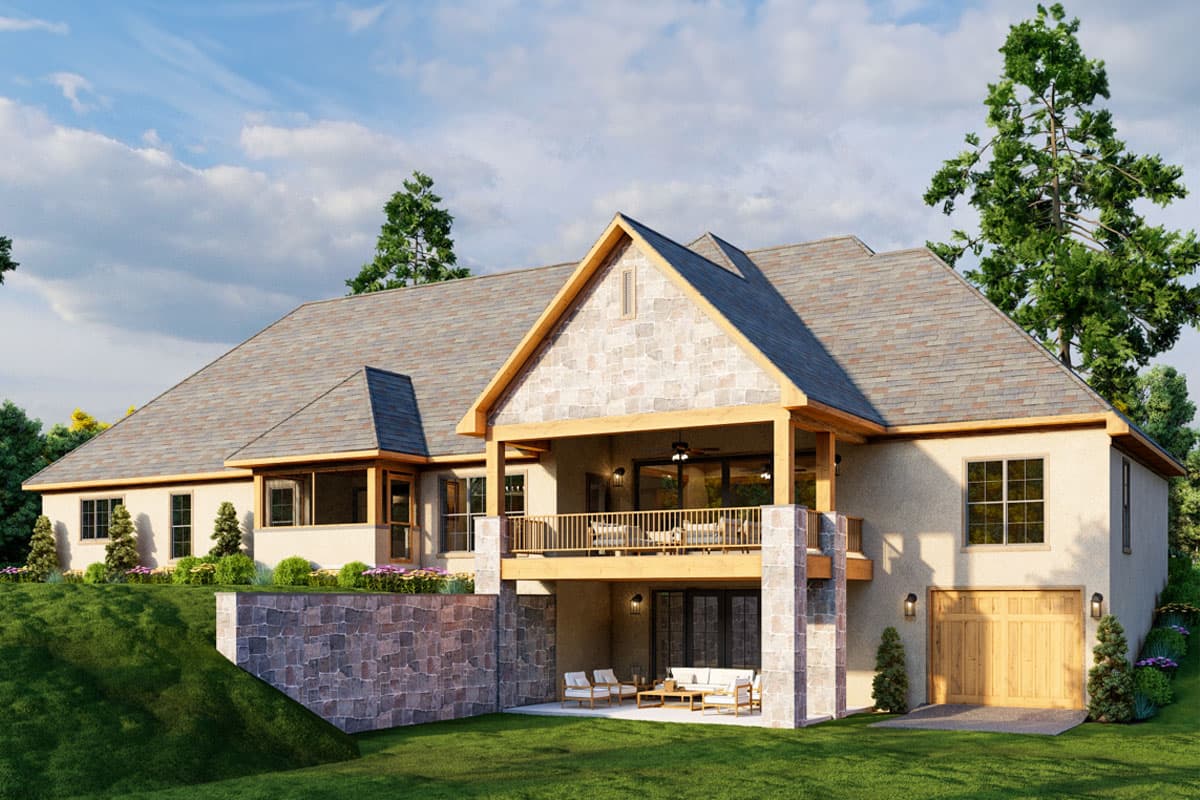 House plan exterior featuring a prominent gable, covered balcony, and stone accents on a sloped lot.
