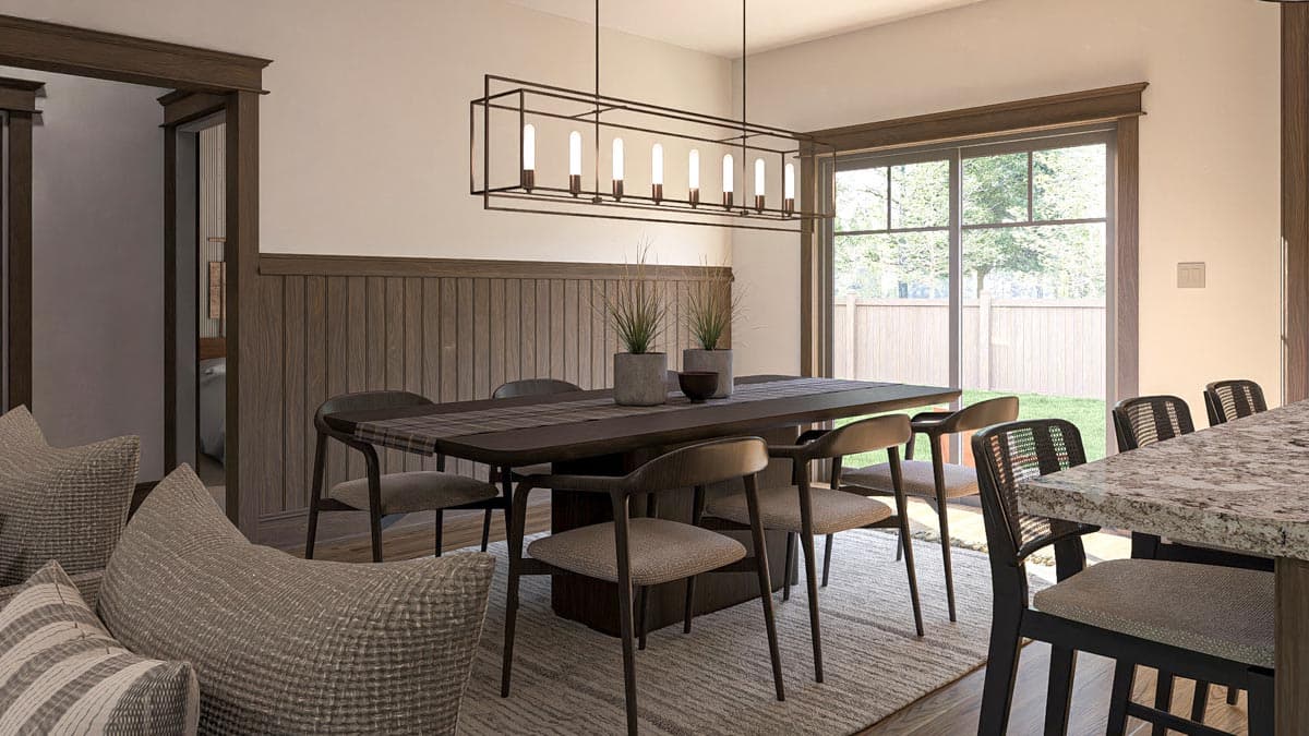 Dining area with wood paneled walls, rectangular dining table and chairs, pendant light, and large windows overlooking backyard.