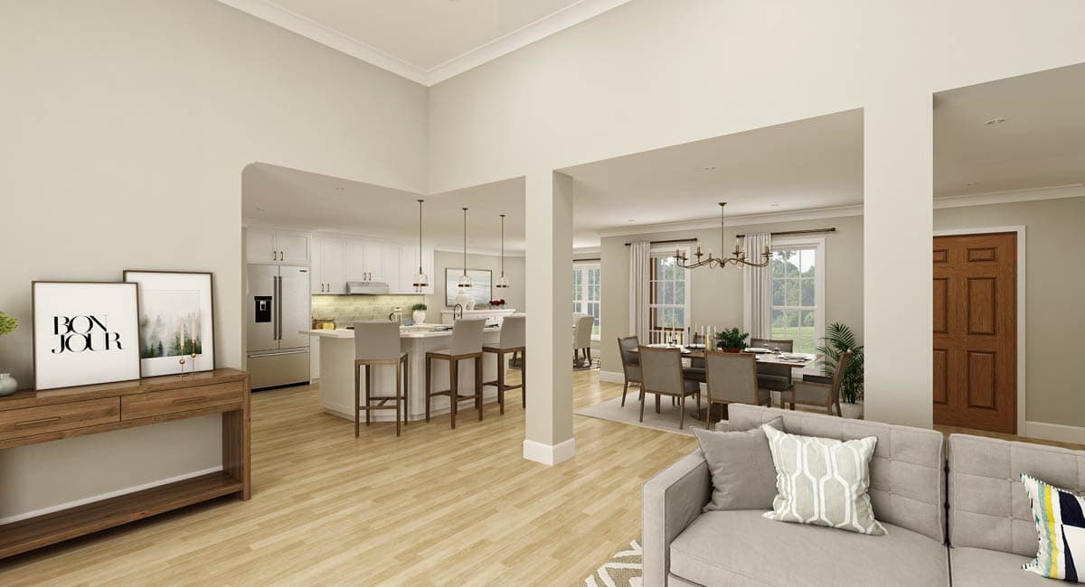 Interior view of open concept living space showing kitchen with island, dining area, and living room with couch.