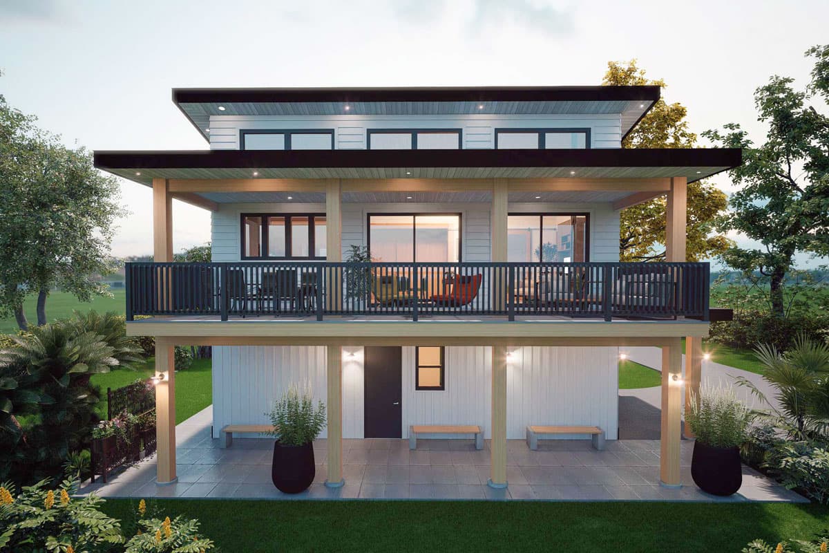 Two-story house plan exterior with a cantilevered second-floor balcony, wide roof overhangs, and a lower-level patio with benches.