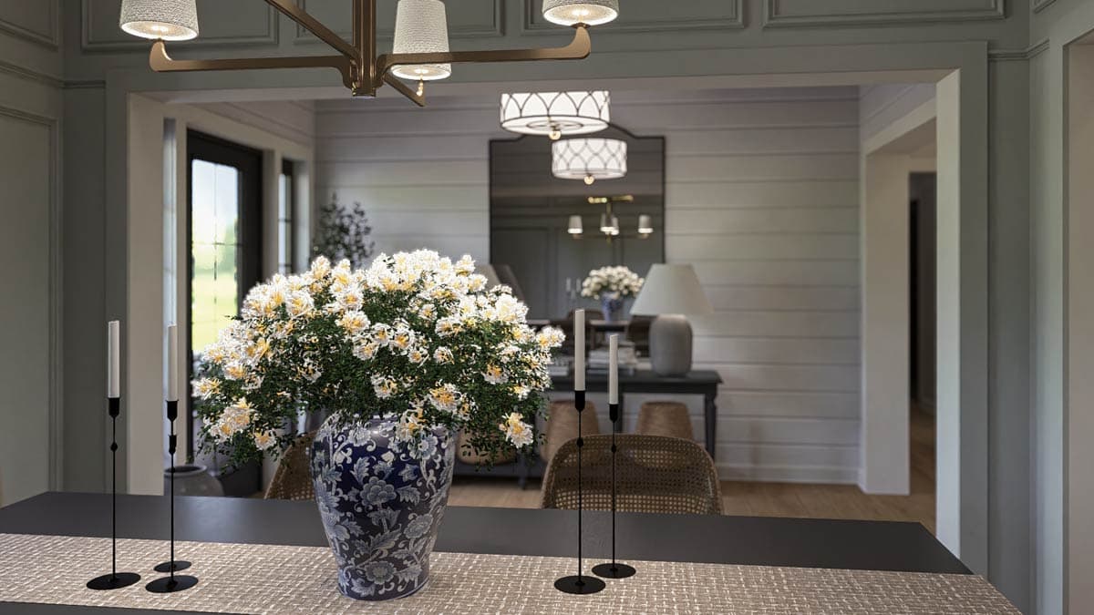 Interior view of dining area with floral arrangement on table, view into adjoining rooms with shiplap walls and decorative lighting.