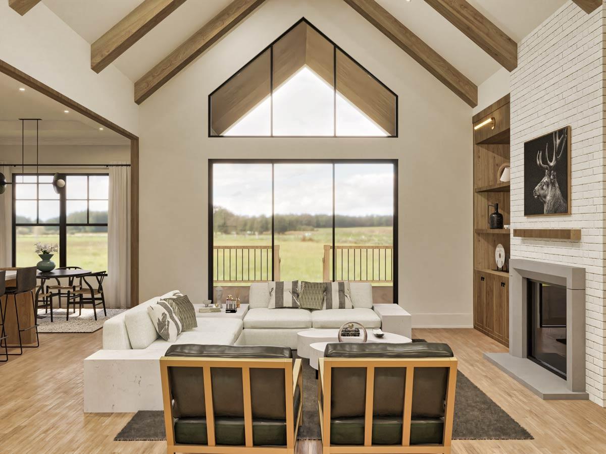 Great room with vaulted ceiling, exposed beams, fireplace, and large picture window with view.