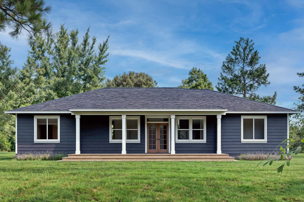Ranch style house plan exterior with a gabled roof, covered porch with columns, and double entry doors.