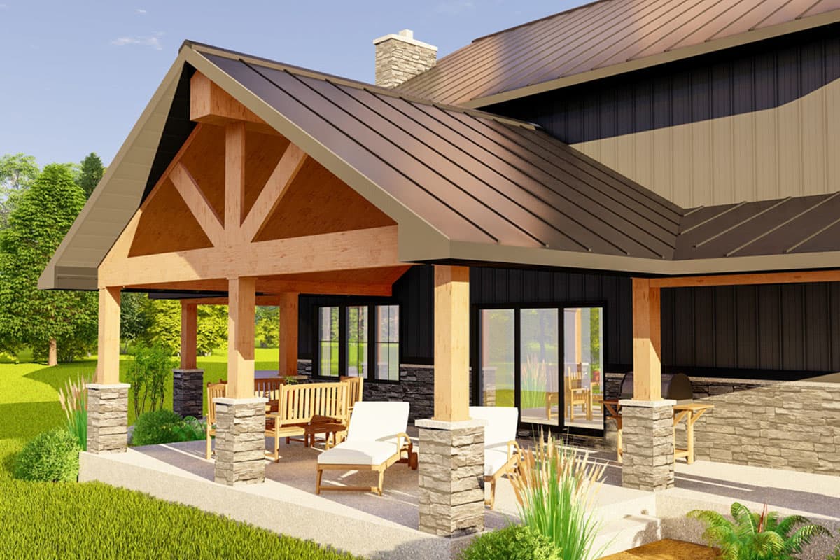 House plan exterior showing exposed timber framing, gabled roof, stone chimney, and covered porch with seating.