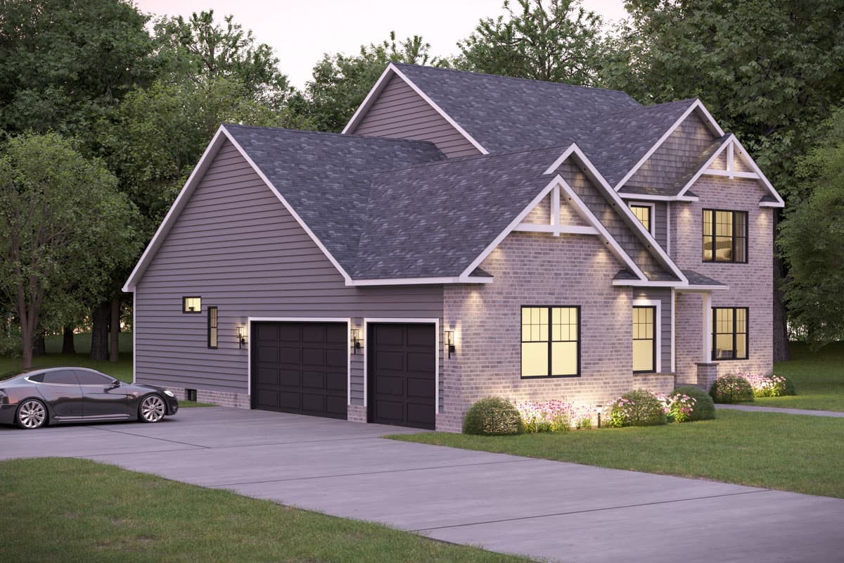A traditional house with a brick facade, two-car garage, and a car parked in the driveway.