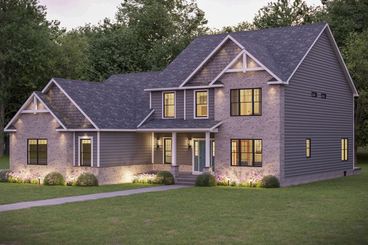 Traditional two-story house with grey siding and brick facade, well-lit with pathway, landscaping, and a green lawn.