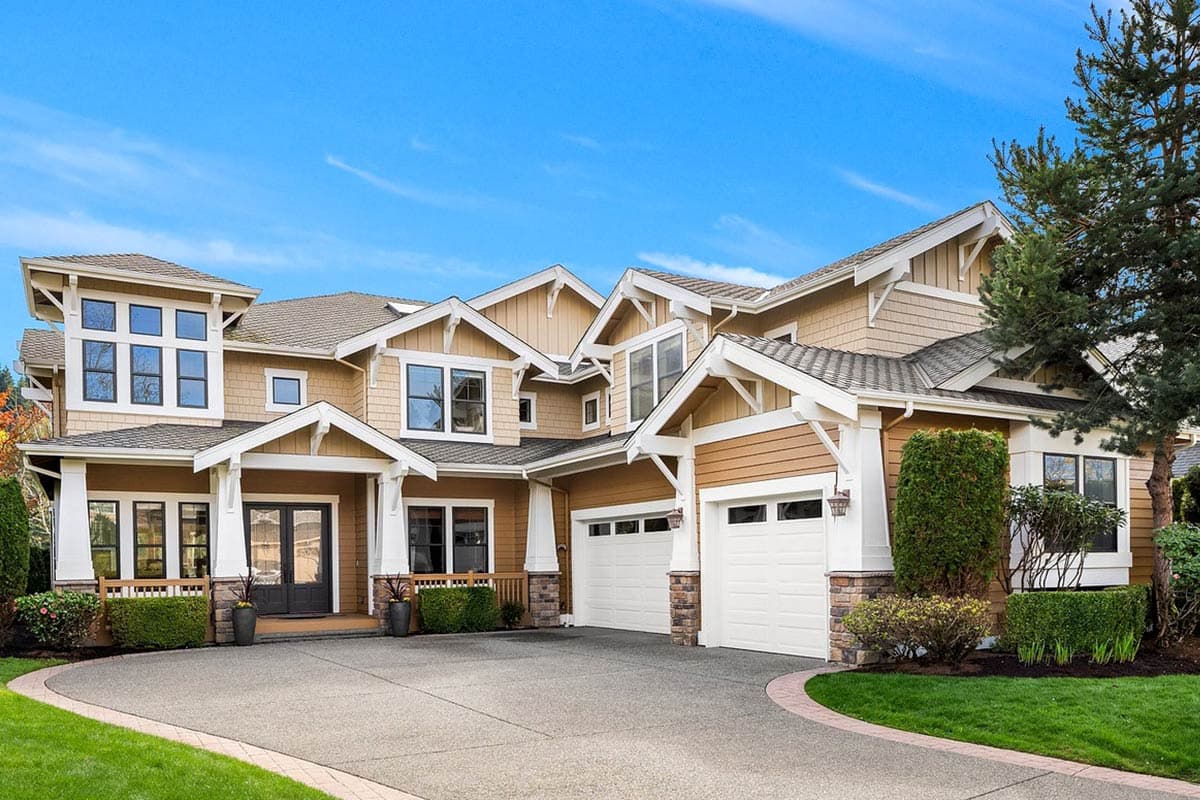 House plan exterior featuring Craftsman-style design. Two-story home with multiple gables, a covered porch, and a three-car garage.
