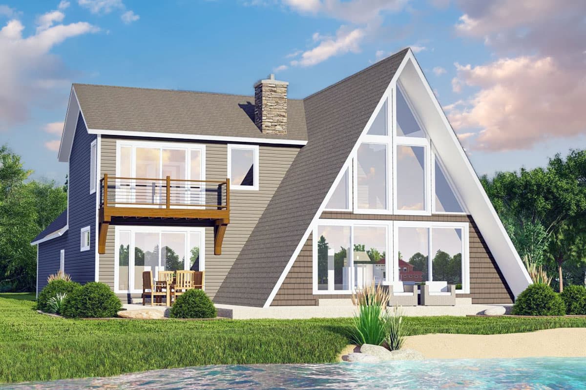 House plan exterior. Two-story A-frame style home with a balcony, large windows, and a stone chimney.